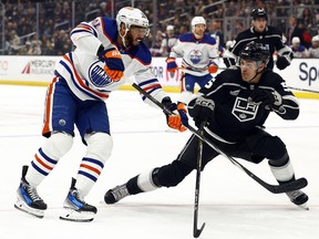 Evander Kane (91) of the Edmonton Oilers skates for the puck against Andreas Englund (5) of the Los Angeles Kings at Crypto.com Arena on Saturday, Feb. 10, 2024, in Los Angeles, Calif.