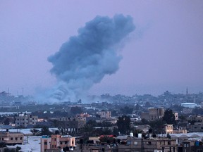 This picture taken from Rafah shows smoke billowing over Khan Yunis in the distance following Israeli bombardment on the southern Gaza Strip on February 15, 2024, amid the ongoing conflict between Israel and the Palestinian Hamas militant group. (Photo by SAID KHATIB / AFP) (Photo by SAID KHATIB/AFP via Getty Images)