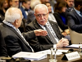 Minister of Foreign Affairs of the Palestinian Authority Riyad al-Maliki (R) listens to a colleague during a hearing at the International Court of Justice (ICJ) on the legal consequences of the Israeli occupation of Palestinian territories, in The Hague on February 19, 2024. (Photo by ROBIN VAN LONKHUIJSEN/ANP/AFP via Getty Images)