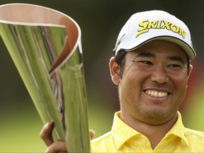 Hideki Matsuyama of Japan celebrates with a trophy.