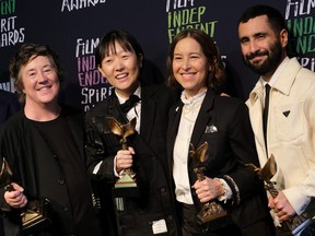 Past Lives producers Christine Vachon, Pamela Koffler and David Hinojosa with director Celine Song hold the award for best feature.