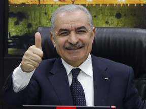 Palestinian Prime Minister Mohammad Shtayyeh gives a thumb up at a cabinet meeting during which he announced his government's resignation and called for "new political measures" in Ramallah on Feb. 26, 2024, amid the ongoing war in the Gaza Strip.