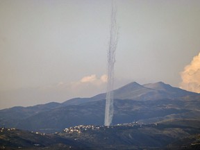 This picture taken from an Israeli position along the border with southern Lebanon shows rockets fired from Lebanon into Israel on February 26, 2024. (Photo by JALAA MAREY/AFP via Getty Images)