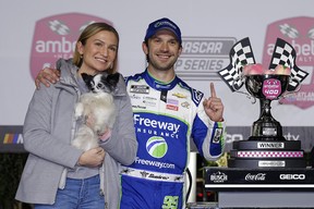 Daniel Suarez, driver of the #99 Freeway Insurance Chevrolet, celebrates with Julia Piquet in victory lane after winning the NASCAR Cup Series Ambetter Health 400 at Atlanta Motor Speedway on February 25, 2024 in Hampton, Georgia. (Photo by Todd Kirkland/Getty Images)