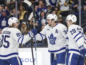 Maple Leafs defenseman William Lagesson (85) and right wing Pontus Holmberg (29) celebrate centre Auston Matthews' goal against the Golden Knights during the third period in Las Vegas, Thursday, Feb. 22, 2024.