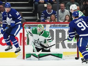Dallas Stars goaltender Scott Wedgewood is scored on as Maple Leafs' Mitch Marner jumps out of the way of the shot during the first period in Toronto on Wednesday, Feb. 7, 2024.