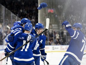 A fan throws a hat onto the ice to celebrate Toronto Maple Leafs centre Auston Matthews third goal.