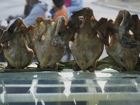 Grilled chickens displayed for selling