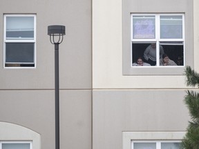 Students look outside their dorm window