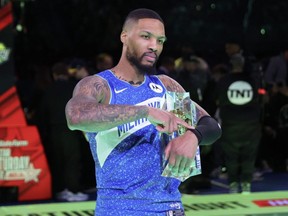 Damian Lillard of the Milwaukee Bucks celebrates after winning the 2024 Starry 3-Point Contest during the State Farm All-Star Saturday Night at Lucas Oil Stadium in Indianapolis, Saturday, Feb. 17, 2024.