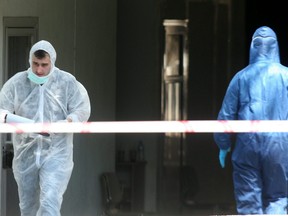 In this file photo taken on May 14, 2010, police investigators search a courthouse building after a bomb explosion in the northern Greek port city of Thessaloniki.