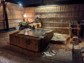 Hydrogen carbonate spring water fills the massive tub carved in the public bathhouse at Wasure-no-sato Gajoen.