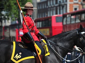A female member of the Royal Canadian Mounted Police (RCMP) stands guard at Horse Guards Parade in central London.