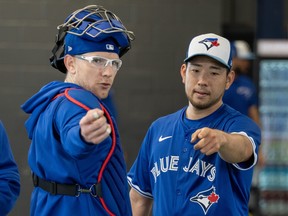 Toronto Blue Jays pitcher Yusei Kikuchi talks with catcher Danny Jansen.