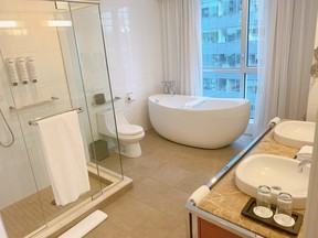 The Premier Suite at Warwick Le Crystal in Montreal features a spacious walk-in shower and soaking tub.