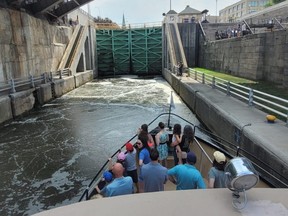 A boat operated by Lockport Locks & Erie Canal Cruises approaches a lock on the Erie Canal in Lockport, N.Y.