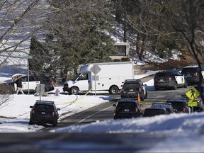 Law enforcement vehicles are parked near the scene where two police officers and a first responder were shot and killed Sunday, Feb. 18, 2024, in Burnsville, Minn.