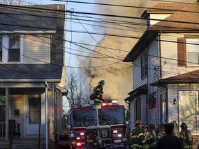 Firefighters work the scene where two police officers were injured Wednesday, Feb. 7, 2024, while responding to reported standoff in East Lansdowne, Pa.