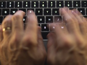 A man uses a computer keyboard in Toronto in a Sunday, Oct. 9 photo illustration.