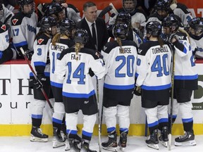 Toronto coach Troy Ryan meets with the team before a faceoff against Minnesota during the third period of a PWHL hockey game in St. Paul, Minn., Jan. 10, 2024.