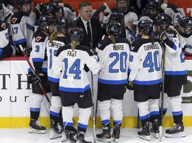 Toronto coach Troy Ryan meets with the team before a faceoff against Minnesota during the third period of a PWHL hockey game in St. Paul, Minn., Jan. 10, 2024.