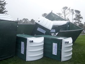Fallen portable toilets are shown at Pebble Beach Golf Links.