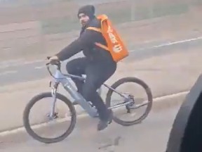 An alleged food delivery cyclist was caught riding on the shoulder of the QEW recently.