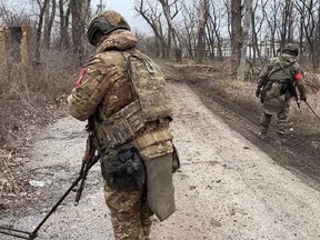 In this photo released by Russian Defense Ministry Press Service on Monday, Feb. 19, 2024, Two soldiers of the Russian military engineering units eliminate the mine danger in the city of Avdiivka, eastern Ukraine.
