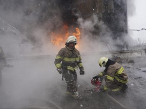 Firefighters extinguish a fire after a Russian attack on residential neighbourhood in Kharkiv, Ukraine Saturday, Feb. 10, 2024.