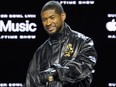 Usher poses for photographers during a news conference ahead of the Super Bowl 58 NFL football game Thursday, Feb. 8, 2024, in Las Vegas.