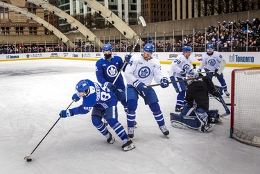 Toronto Maple Leafs Nicholas Robertson, Noah Gregor and Auston Matthews battle for the puck.