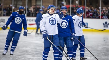 Toronto Maple Leafs forward Matthew Knies shares a laugh with John Tavares.