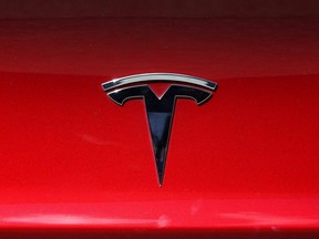 The Tesla logo is displayed on a vehicle in Corte Madera, Calif., April 26, 2021.