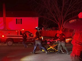 First responders carry an injured person away after an explosion at a home, late Friday, Feb. 16, 2024, in Sterling, Va.