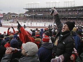 In this file photo taken on Jan. 1, 2009 , Amy Schneider, of Chicago, holds up a drink during the NHL Winter Classic hockey game between the Detroit Red Wings and the Chicago Blackhawks at Wrigley Field in Chicago.