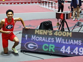 Canadian Christopher Morales Williams poses for a photo next to his result during the NCAA Southeastern Conference indoor championships, in Fayetteville, Ark., in a Sunday, Feb. 25, 2024, handout photo. THE CANADIAN PRESS/HO-University of Georgia, Wesley Hitt, *MANDATORY CREDIT*