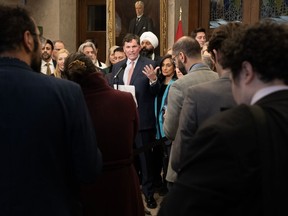 Reporters, staffers and Members of Parliament listen to Minister of Public Safety, Democratic Institutions and Intergovernmental Affairs Dominic LeBlanc speak about auto theft, Wednesday, February 7, 2024 in Ottawa. The federal government says an estimated 90,000 cars are stolen annually in Canada, resulting in about $1 billion in costs to Canadian insurance policy-holders and taxpayers.