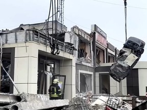 In this photo taken from video released by Russian Emergency Ministry Press Service on Saturday, Feb. 3, 2024, Russian Emergency Ministry employees work at the side of a collapsed bakery after an attack of Ukrainian troops, that Russian officials in Luhansk said was conducted by Ukrainian forces, in Lysychansk, Russian-controlled Luhansk region, eastern Ukraine. According to the Russian Emergency Ministry, five people were found dead under the rubble. Eight people were injured and there might be dozens of civilians under the debris, Moscow-installed authorities said. Search and rescue efforts continue. (Russian Emergency Ministry Press Service via AP)