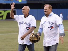 Former Toronto Blue Jays players Jimmy Key, left, and Ernie Whitt walk off the field after the ceremonial first pitch before the start of American League baseball action between the Blue Jays and the St. Louis Cardinals in Toronto on Friday, June 6, 2014. Former Toronto Blue Jays all-stars Russell Martin and Key are headlining the Canadian Baseball Hall of Fame's Class of 2024.