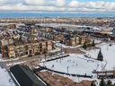 Overhead shot of Brampton neighborhood and park where people are skating on outdoor pond.