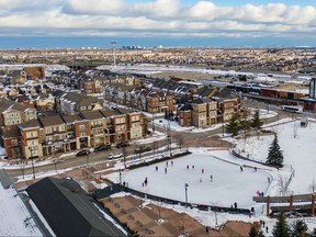 Overhead shot of Brampton neighbourhood and park where people are skating on outdoor pond.