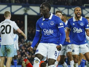 Everton's Amadou Onana, front, celebrates after scoring his side's first goal during the English Premier League soccer match between Everton and Crystal Palace at the Goodison Park stadium, in Liverpool, England, Monday, Feb. 19, 2024.