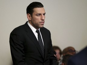 Boston Bruins forward Milan Lucic stands during his arraignment