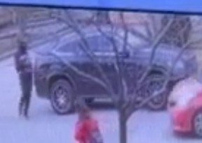 Investigators are looking for the unidentified man seen here standing near a black vehicle belonging to a woman who was carjacked in Mississauga on Feb. 8, 2024.