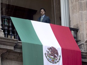 Prime Minister Justin Trudeau looks out from a balcony following a meeting with Mexican President Andres Manuel Lopez Obrador at the National Palace, in Mexico City, Mexico. Wednesday Jan. 11, 2023.