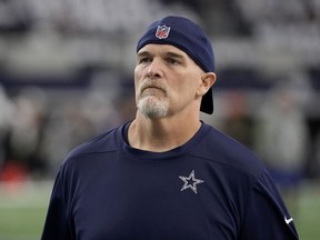 FILE - Dallas Cowboys defensive coordinator Dan Quinn watches players warm up for an NFL football game against the Washington Commanders on Nov. 23, 2023, in Arlington, Texas. Quinn was the 12th candidate to interview for the Los Angeles Chargers head coach opening. Quinn just completed his third season with the Cowboys. He was the Falcons head coach for five-plus seasons (2015-20), where he went 43-42 with a Super Bowl berth after the 2016 season.