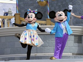 FILE - Minnie and Mickey Mouse perform for guests during a musical show in the Magic Kingdom at Walt Disney World, July 14, 2023, in Lake Buena Vista, Fla. Disney is hoping a recent decision bolstering a Florida prosecutor's First Amendment case against Gov. Ron DeSantis helps its own free speech lawsuit against the Florida governor.