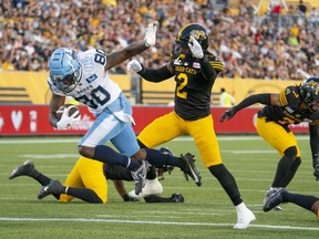 Toronto Argonauts wide receiver DaVaris Daniels (80) gets into the endzone for a touchdown as Hamilton Tiger-Cats defensive back Tunde Adeleke (2) defends during first half CFL football game action in Hamilton, Ont. on Friday, July 21, 2023. The Toronto Argonauts signed Adeleke and linebacker Fraser Sopik on Tuesday, the opening day of CFL free agency.