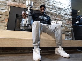 Henoc Muamba of the Toronto Argonauts holds the Grey Cup after arriving at Toronto Pearson International Airport in Mississauga, Ont., Monday, Nov. 21, 2022. Canadian linebacker Muamba has called it a career. The 35-year-old made the announcement on his Instagram account.