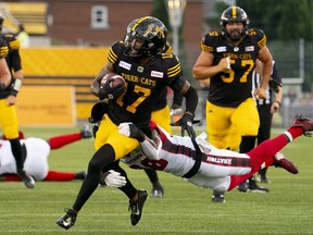 Hamilton Tiger-Cats wide receiver Terry Godwin II (17) is tackled by Ottawa Redblacks linebacker Frankie Griffin (28) during first-half CFL action in Hamilton, Ont. on Saturday, July 8, 2023. The Hamilton Tiger-Cats re-signed Godwin II on Tuesday.